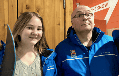 A dad, Gary, with his daughter, dressed in winter gear from a ski trip.