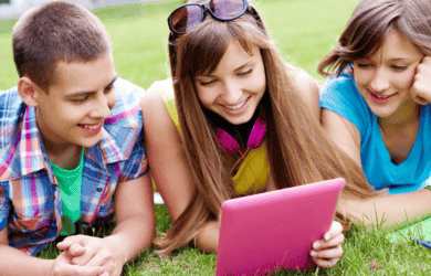 Teens smiling at device