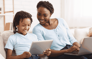 Mother and child happy on devices