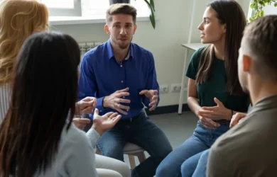 A group of young adults talk with each other.